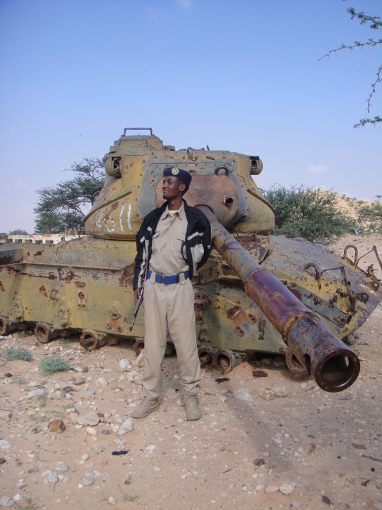 Our guard posing next to the wreck of a somali tank
